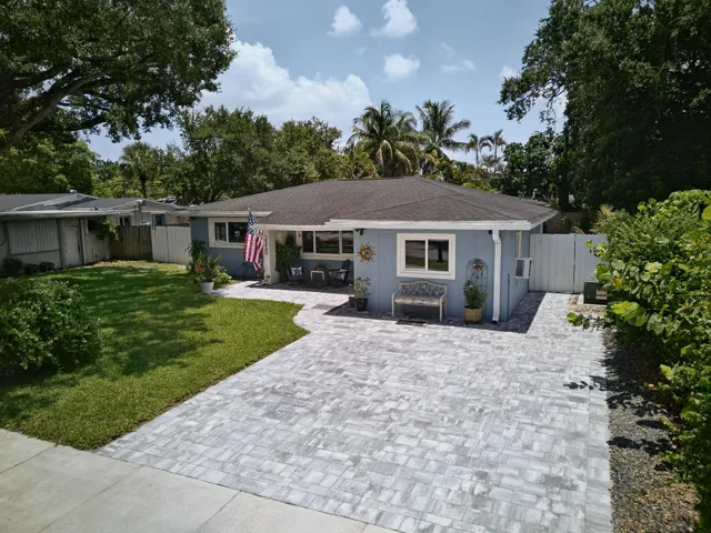 Aerial view of front of home. Nice spacious paver driveway