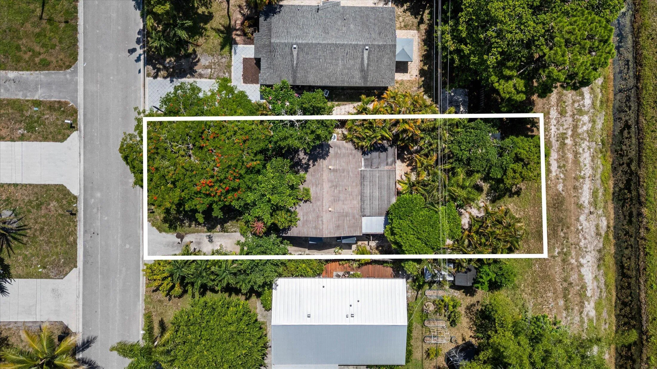 Aerial perspective showcasing a residential property with a partial canal border