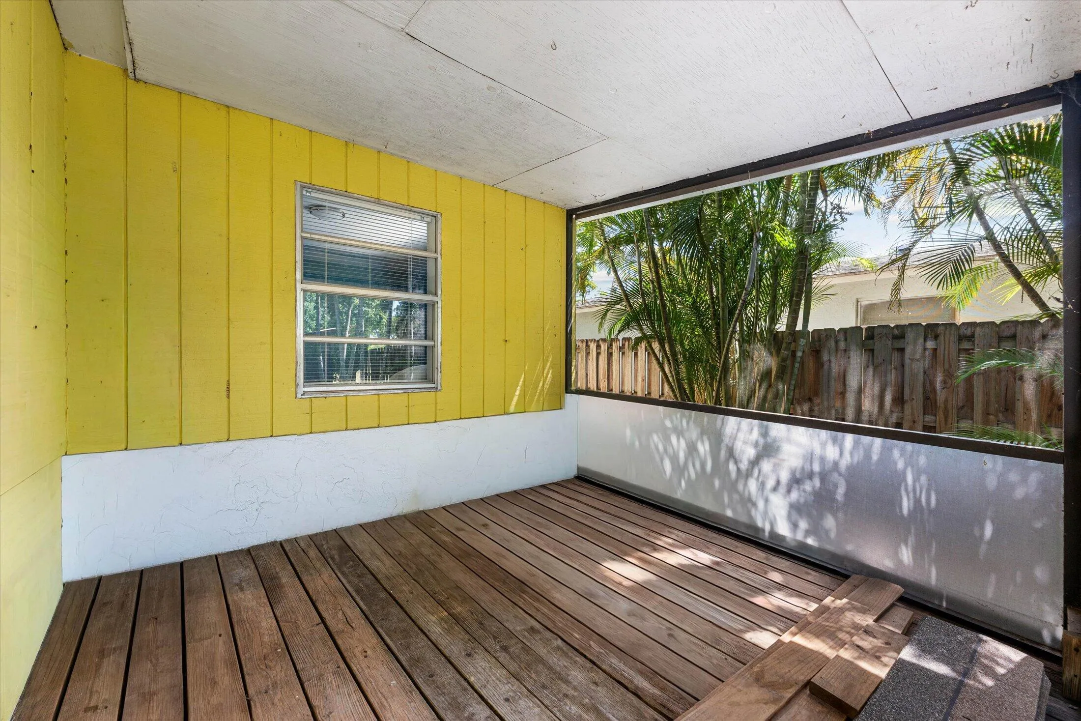 Screened outdoor living area featuring wood-finish flooring