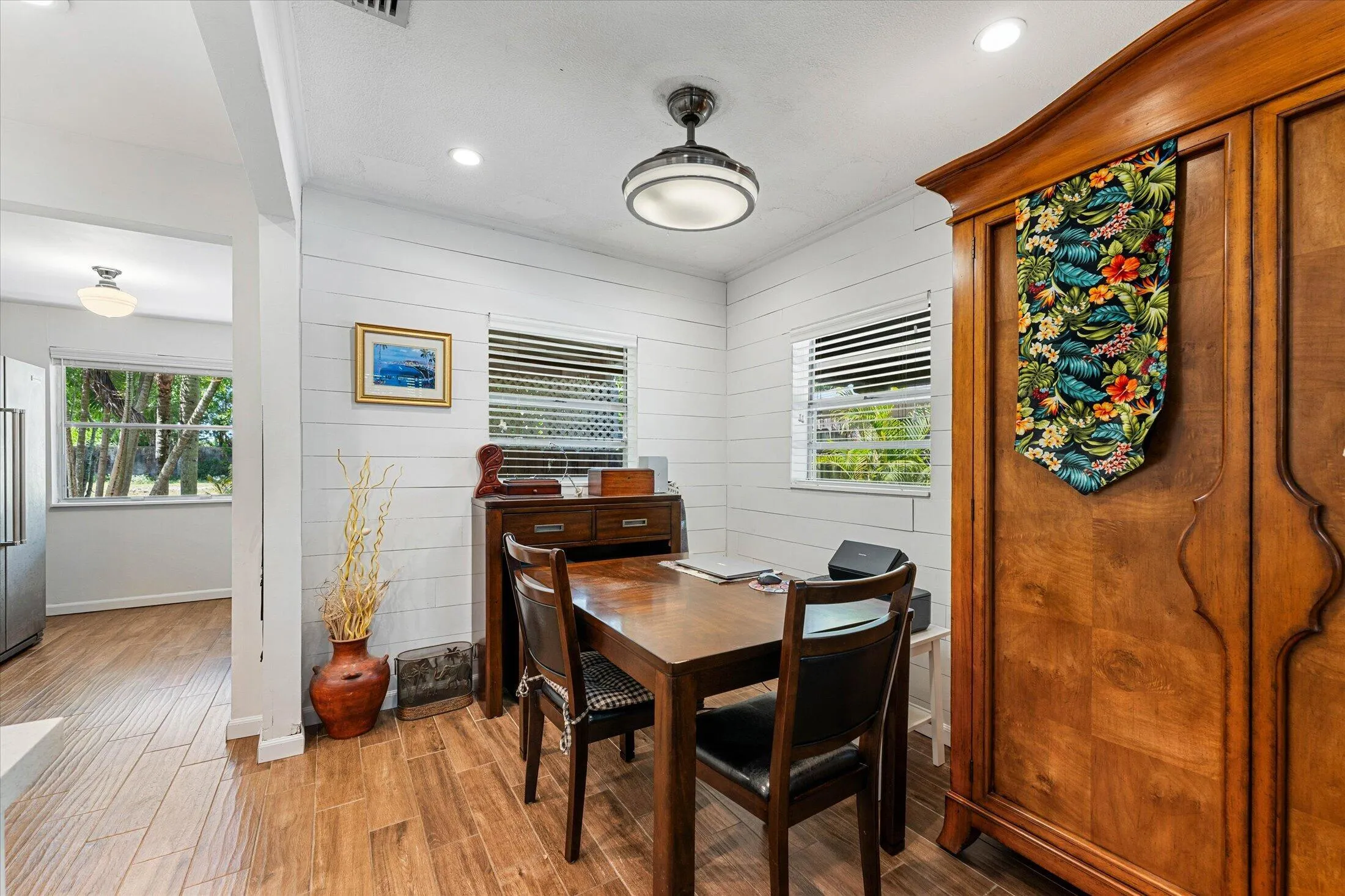 Dining area featuring wood-finish flooring, shiplap wall treatment, recessed lighting, and a flush-mount ceiling fixture