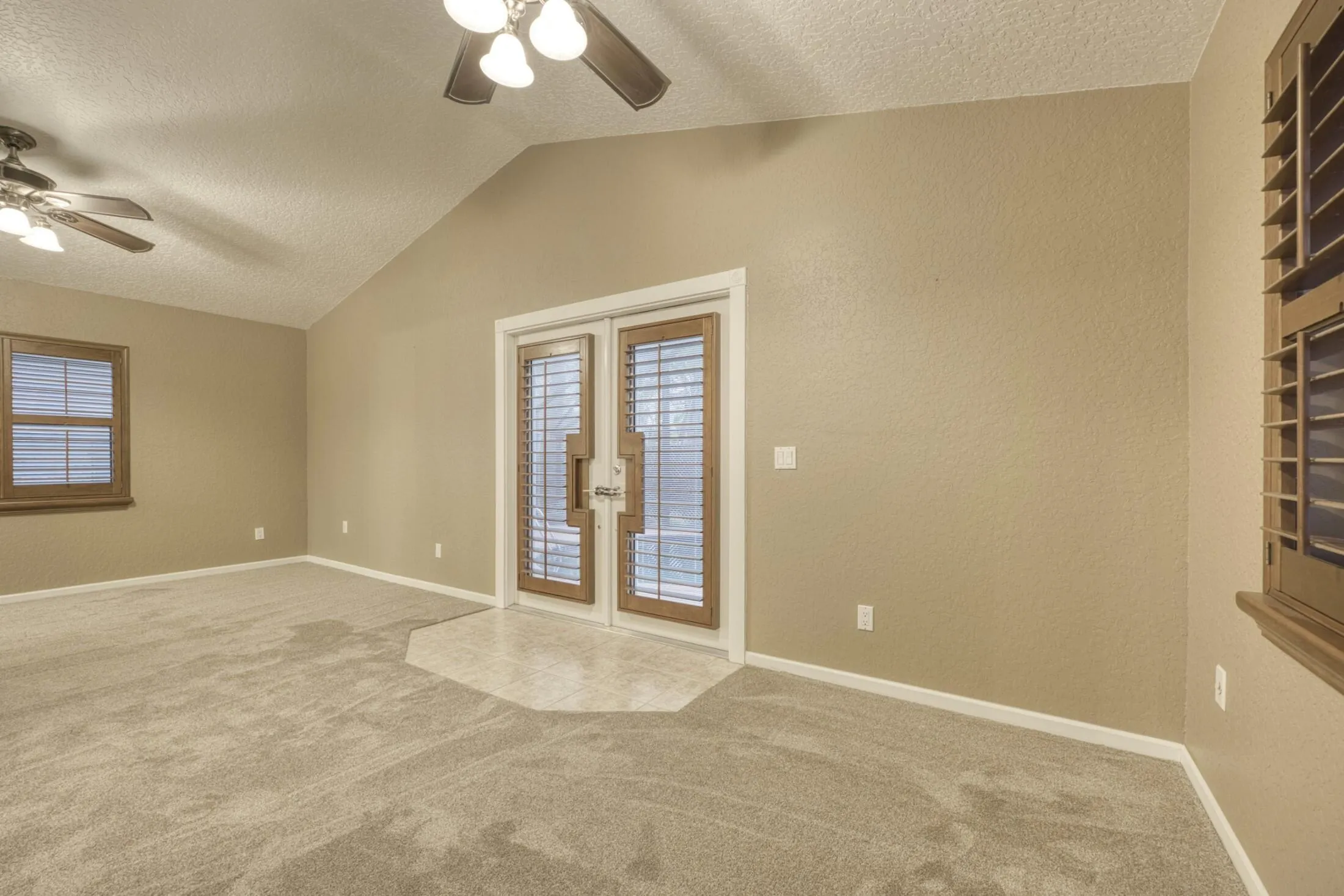 MASTER BEDROOM WITH DOORS OUT TO POOL