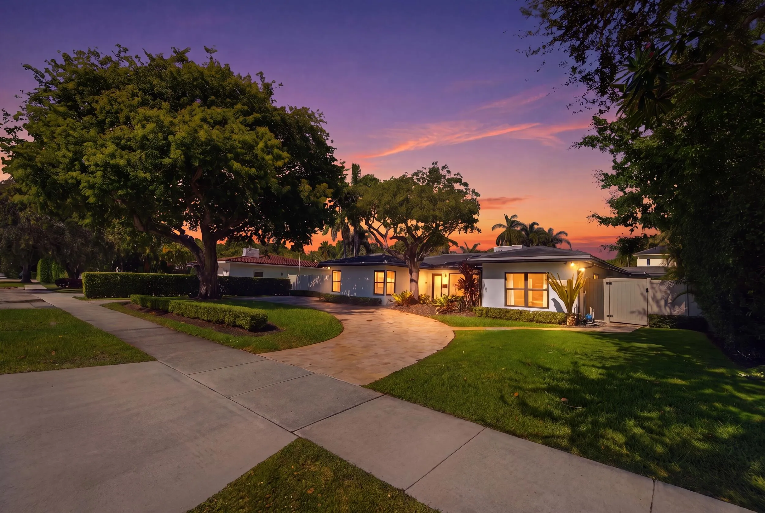 Contemporary single-story residence with a paved circular driveway