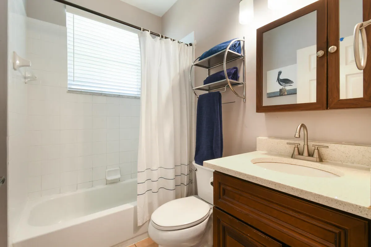 Bathroom vanity with a light-toned countertop and an undermount sink