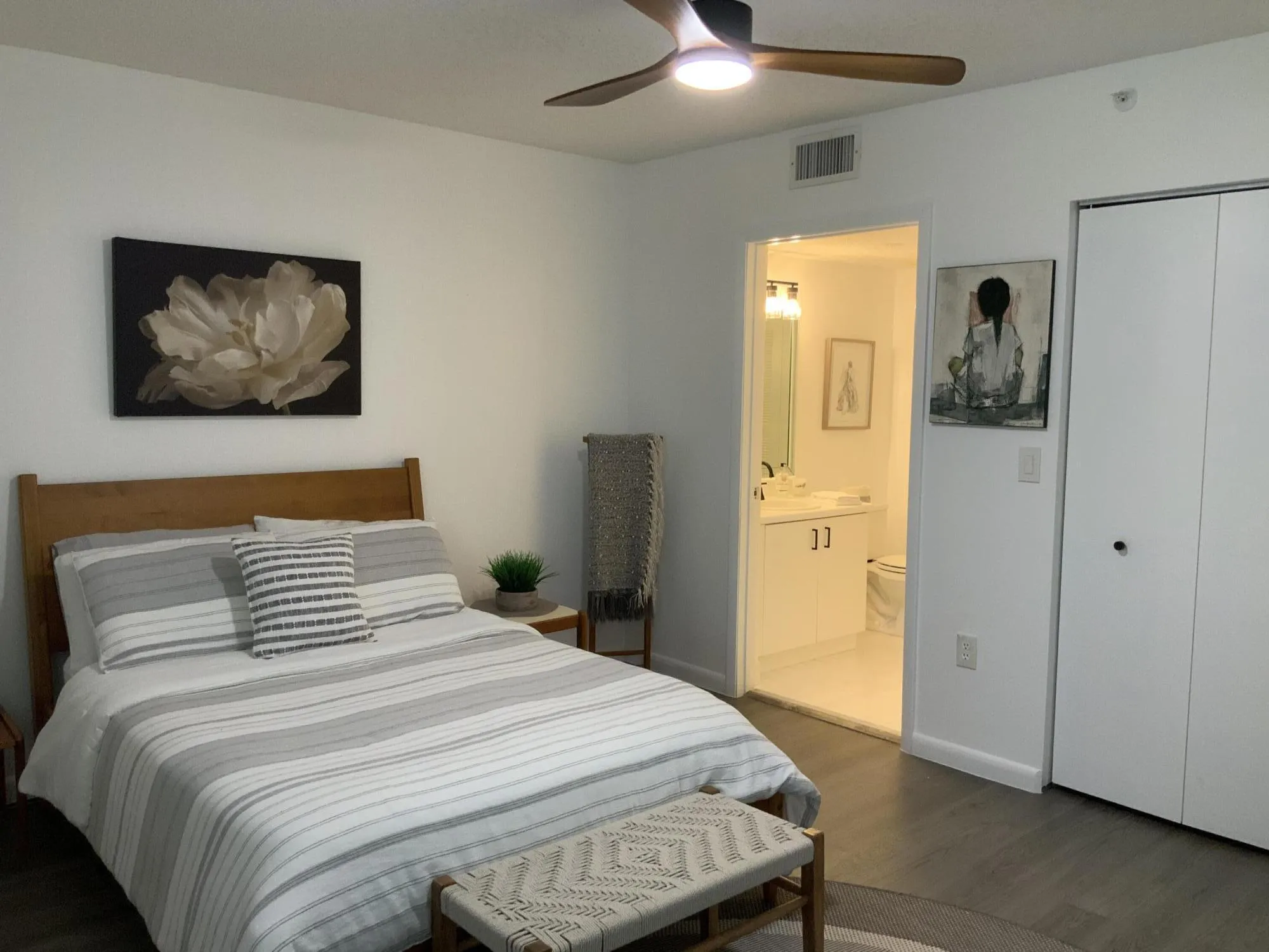 Master bedroom with walk in closet and new ceiling fan.