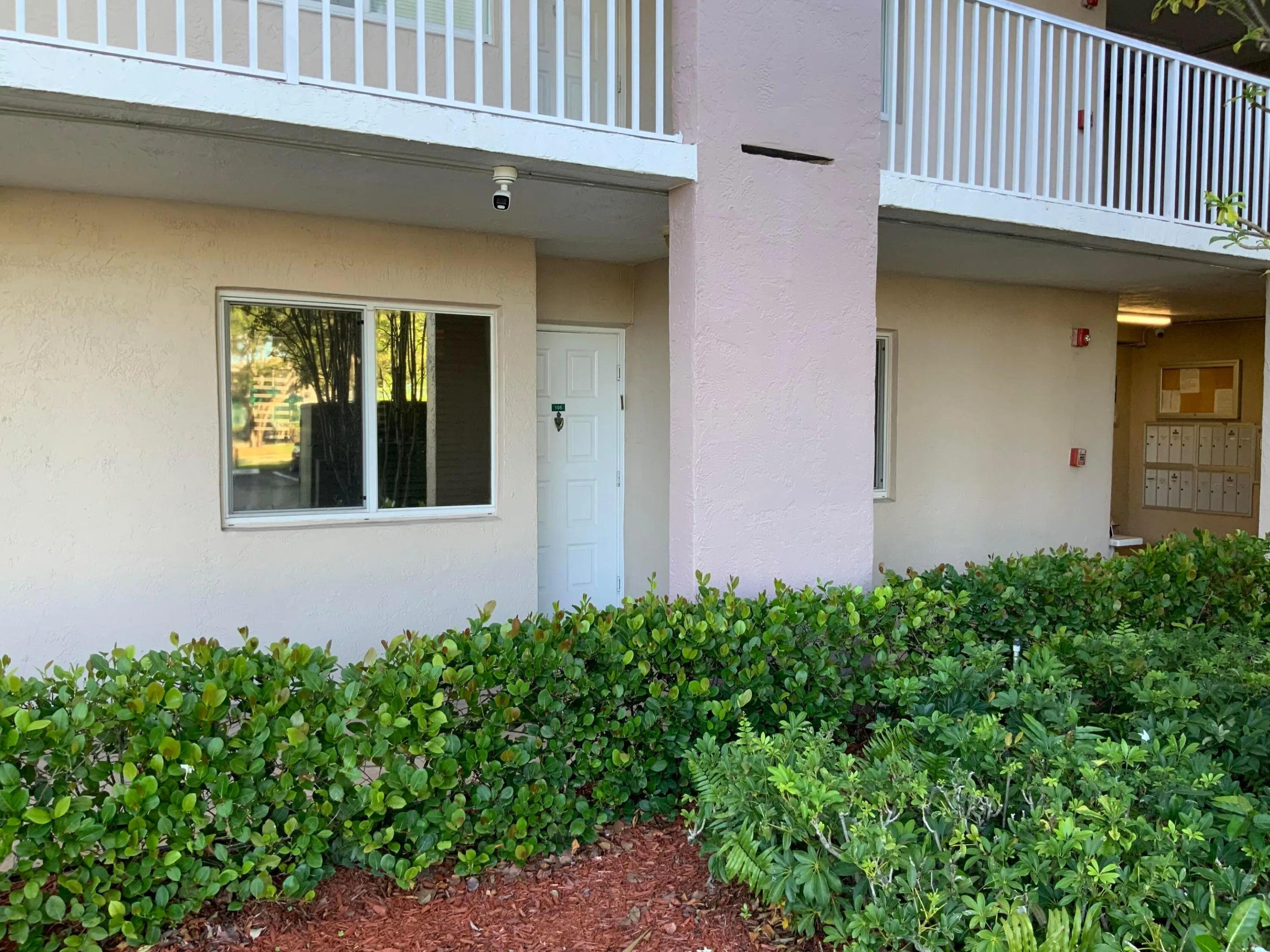 Shaded front door next to mailbox