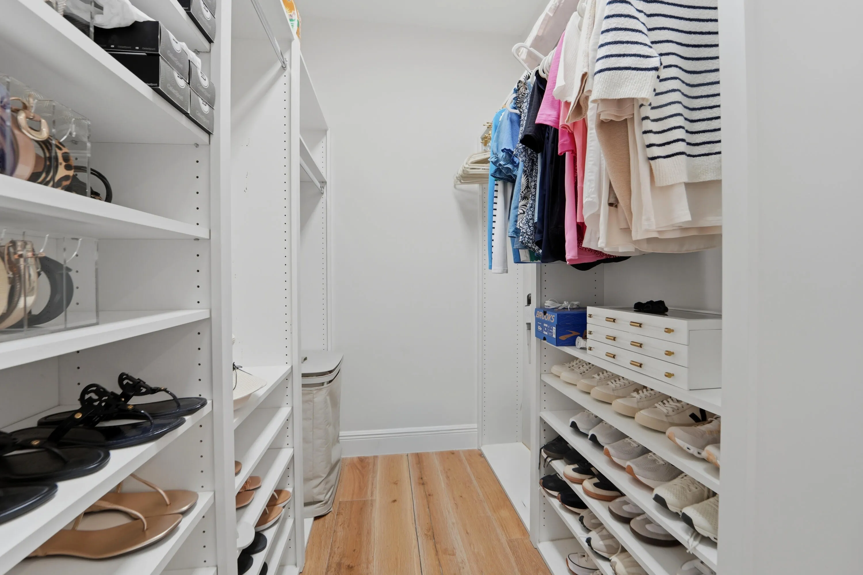 one of the walk in closets in the primary bedroom