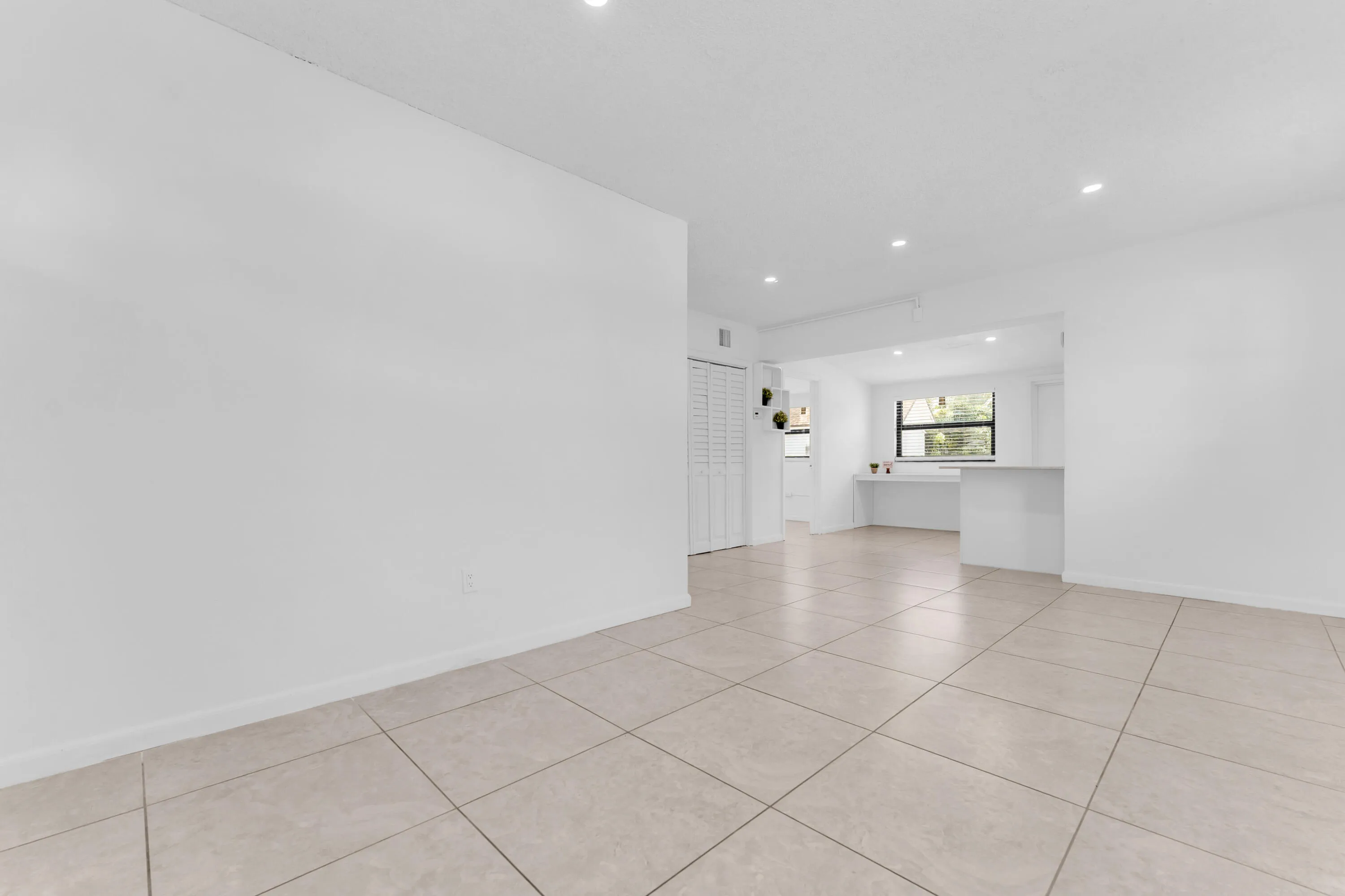 Neutral tile flooring extends through the space