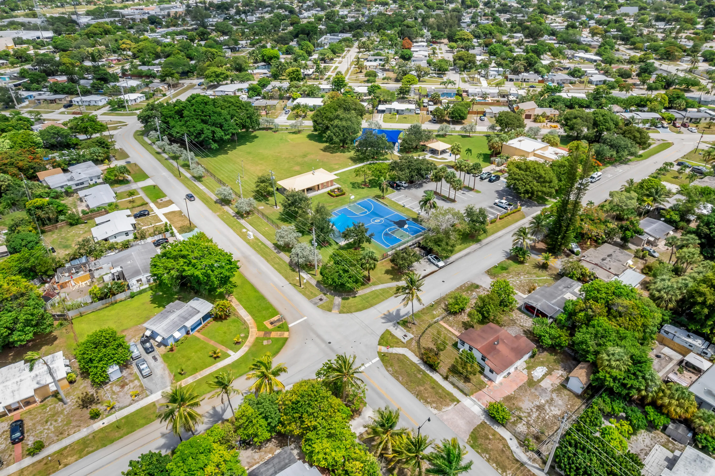 Aerial perspective showcasing a residential neighborhood with a central park space