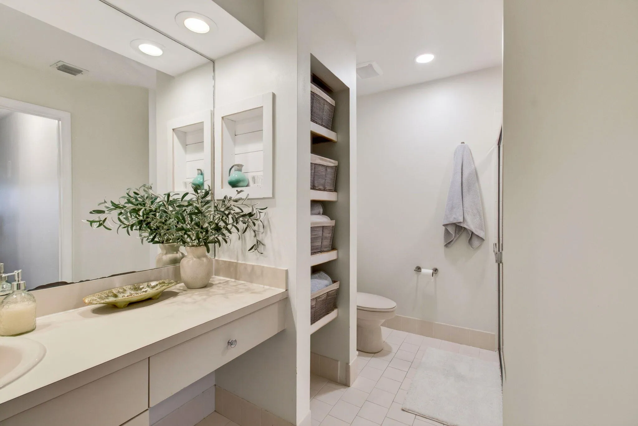 Bathroom vanity with an integrated sink and light-colored countertop