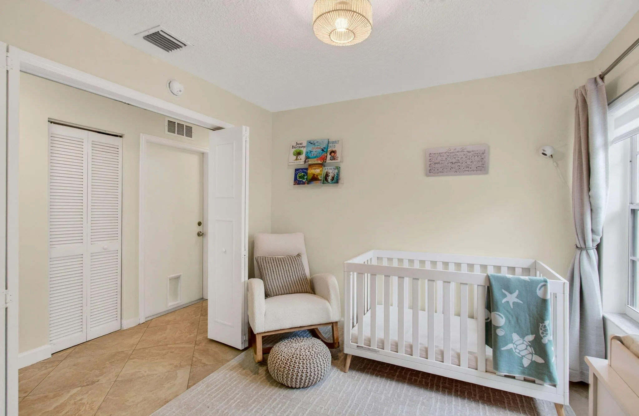 Neutral-toned room with a ceiling-mounted woven light fixture