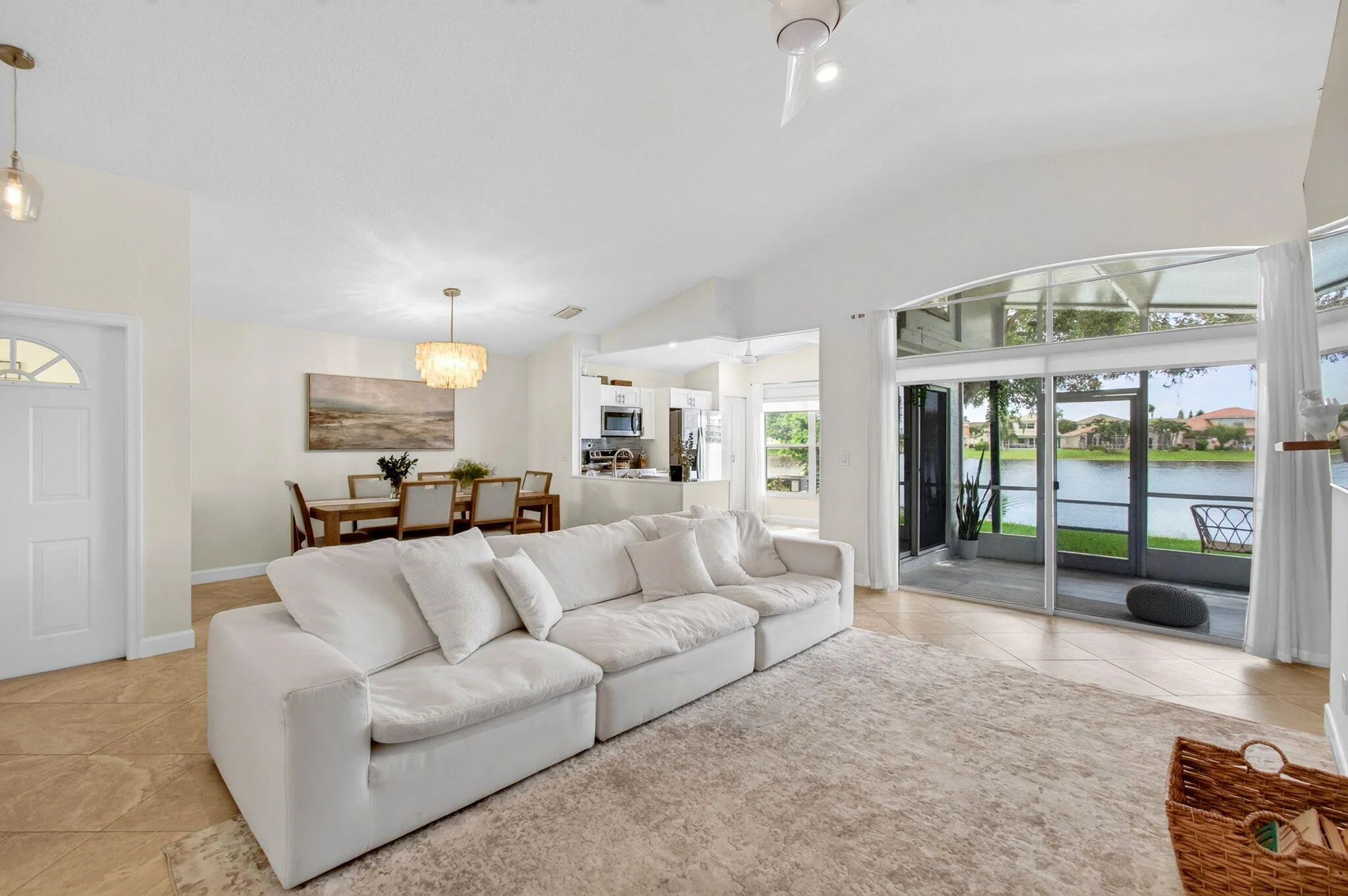 Spacious living area featuring vaulted ceilings and tile flooring