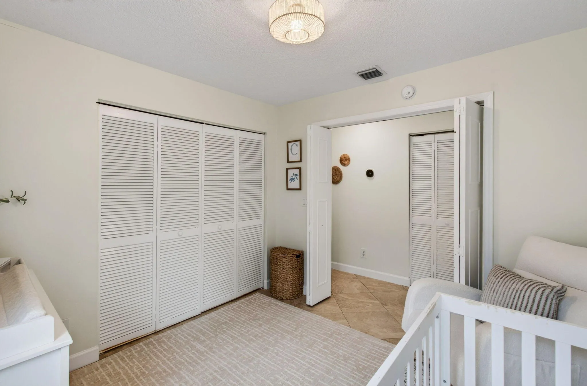 Bright interior room featuring a louvered bi-fold closet, recessed lighting, and a circular flush-mount ceiling fixture