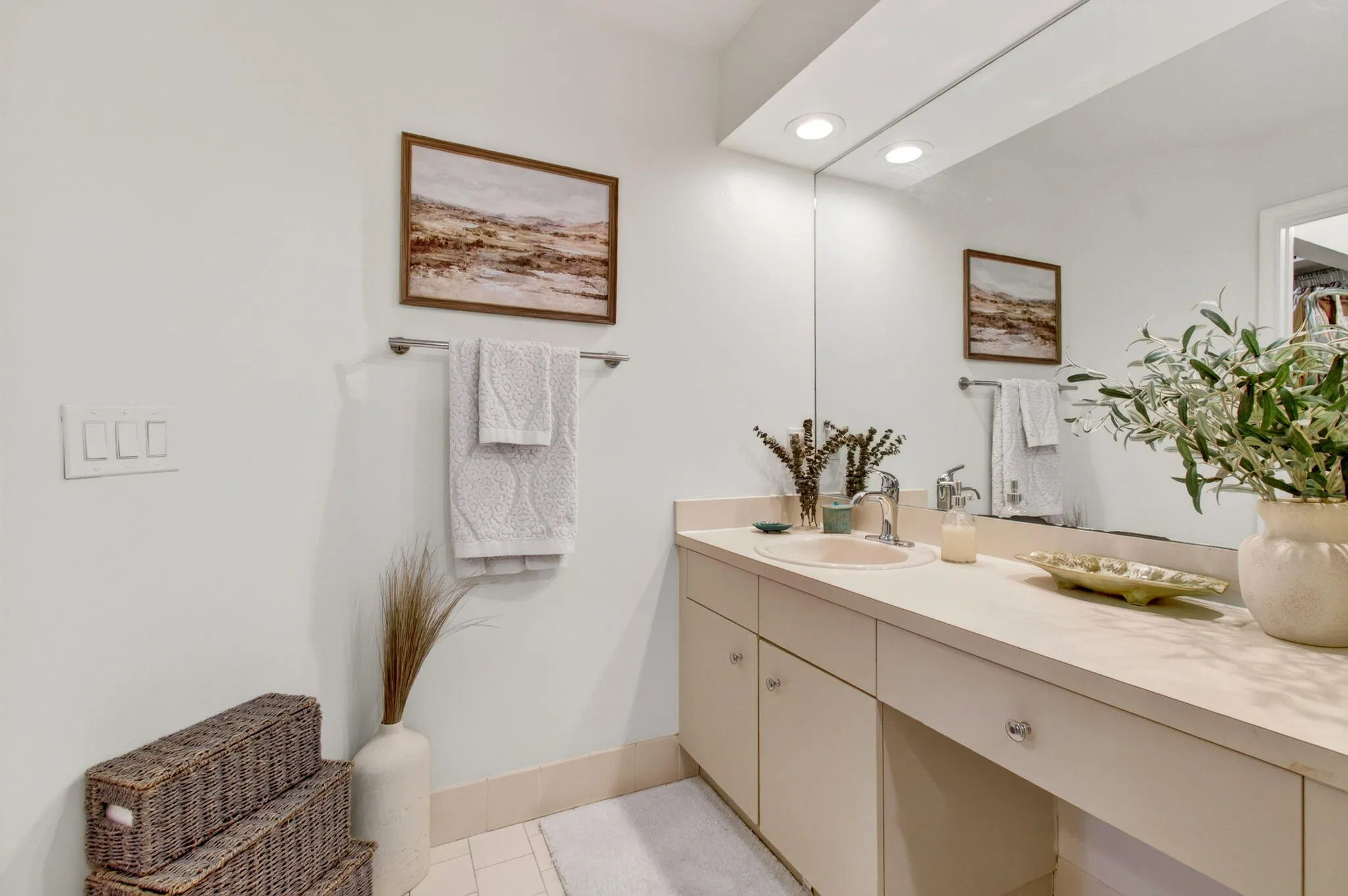 Bathroom vanity featuring an integrated sink, polished chrome faucet, and ample countertop space