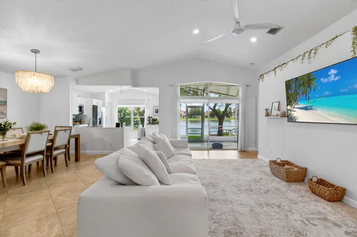 Vaulted ceilings with recessed lighting, tile flooring, and a ceiling fan