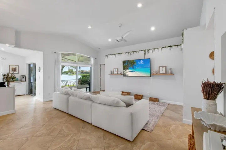 Open-concept living space featuring vaulted ceilings and recessed lighting