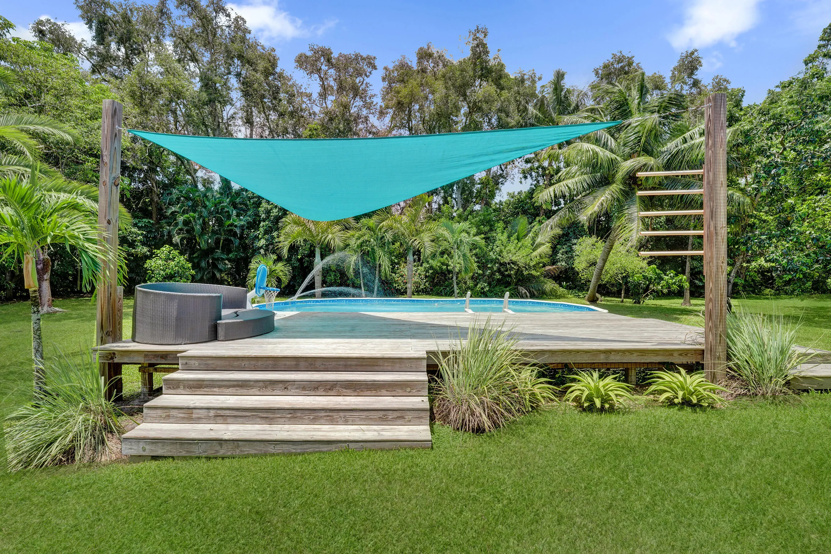 Wood deck around the pool with sunshade