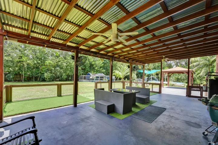 Covered side patio with additional small fenced area, great for kids and pets- has turf too!!
