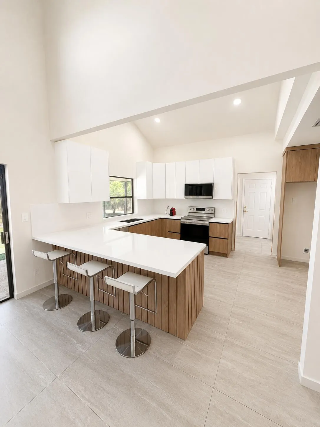 Modern kitchen featuring a large island with wood-finish paneling and a light-toned countertop
