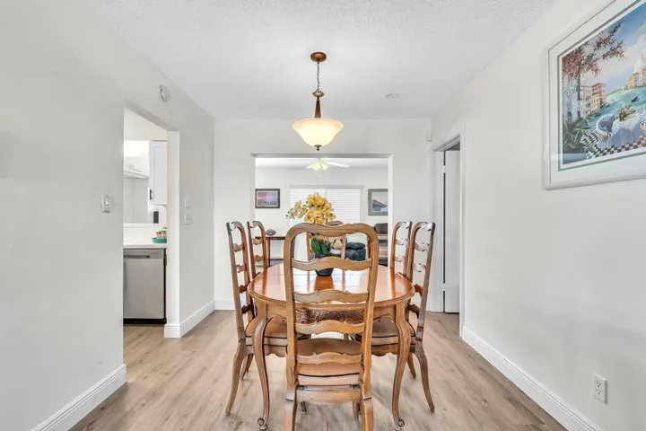 Dining area featuring wood-finish flooring and a central pendant light fixture