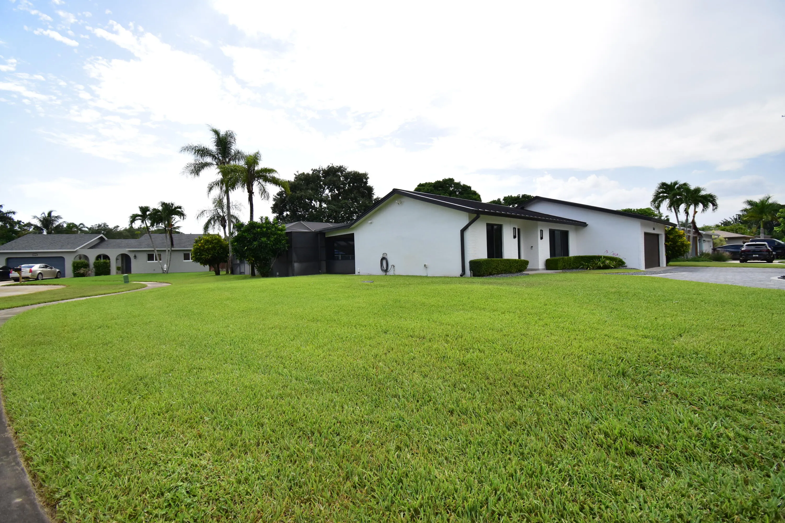 Spacious front yard with expansive green lawn