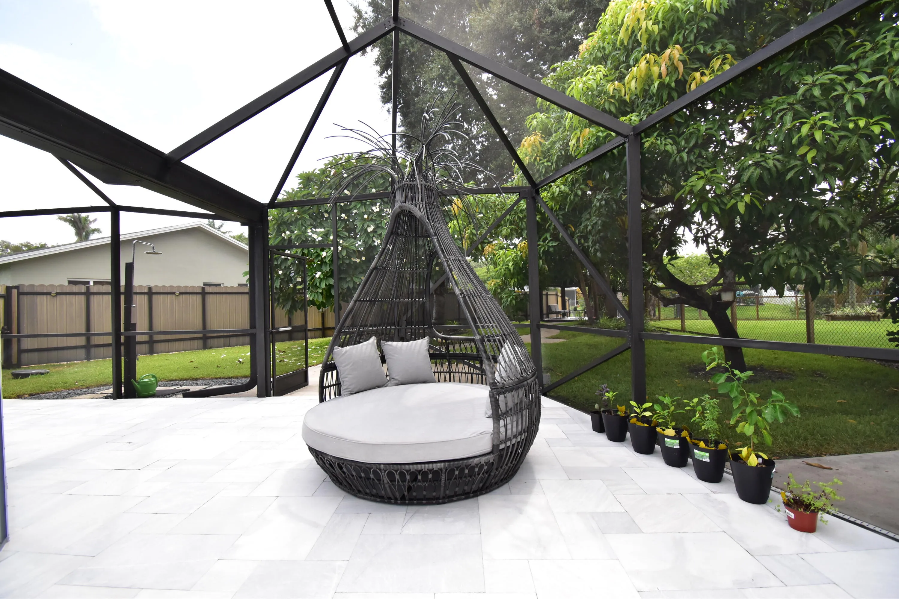 Screened patio enclosure featuring light-toned tile flooring