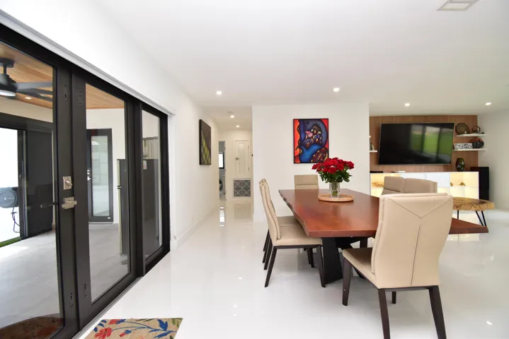 Spacious interior featuring white tile flooring and recessed lighting throughout