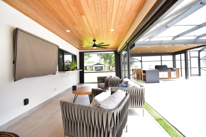 Expansive covered patio featuring a wood-finish ceiling, recessed lighting, and a ceiling fan