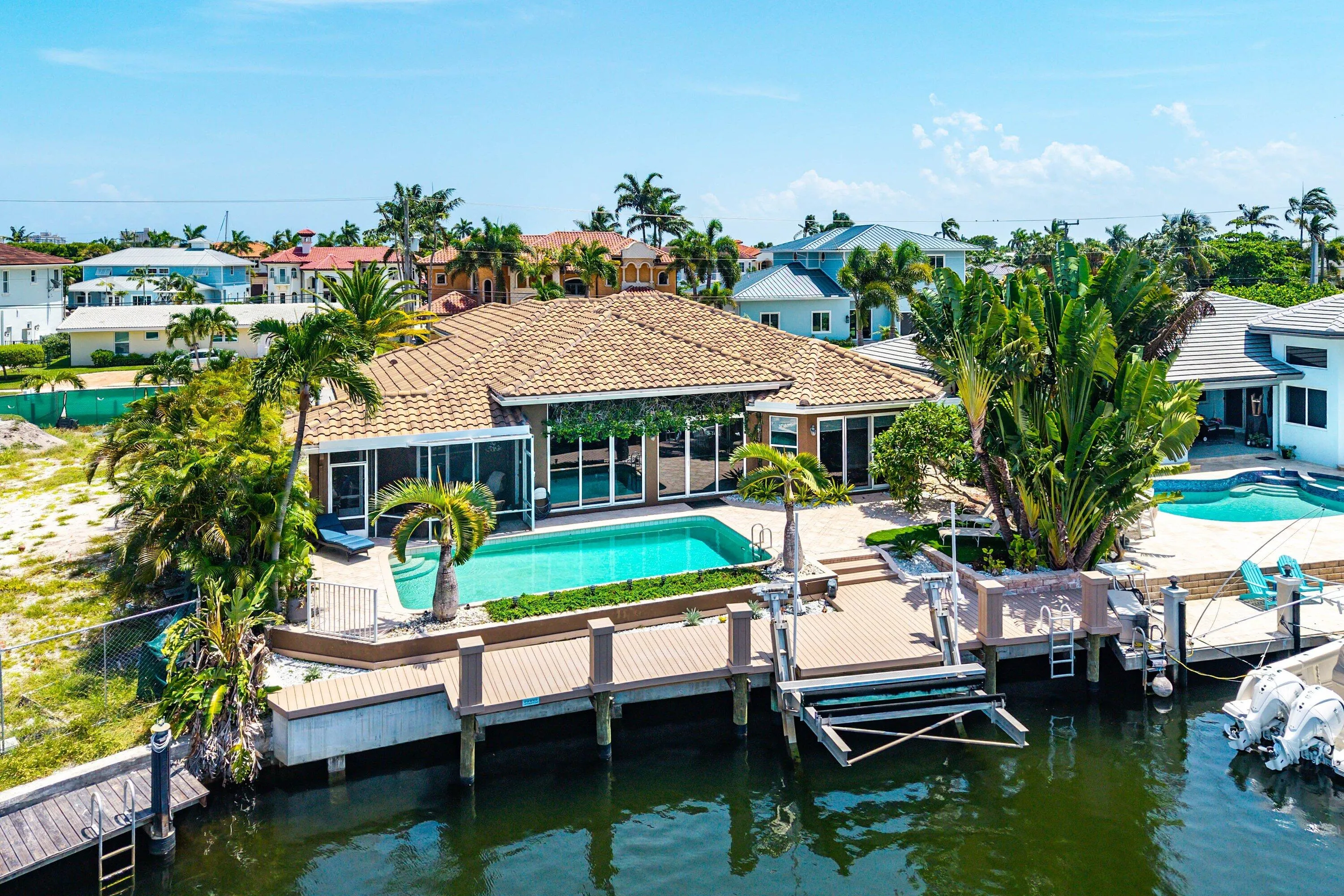 Waterfront property featuring a private pool, new boat dock with boat lift, and direct ocean and intracoastal access just minutes from the Hillsboro Inlet.