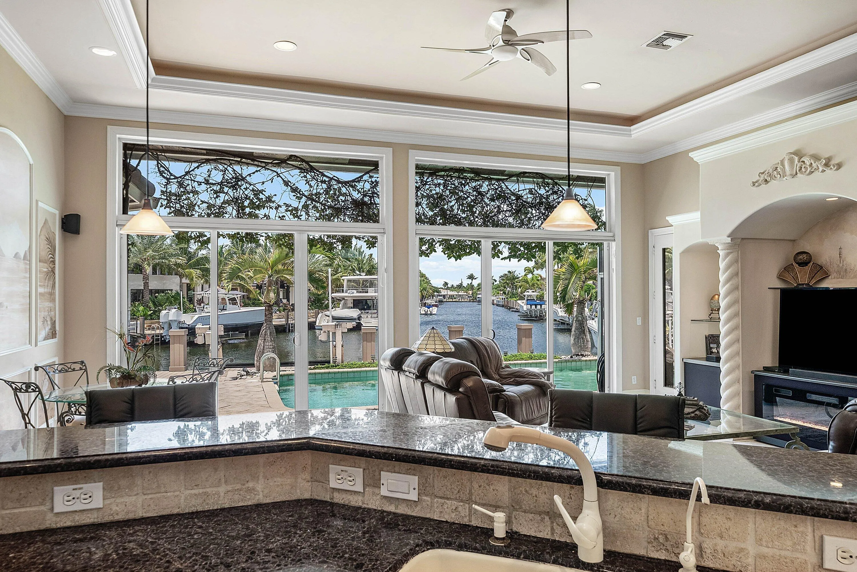 Gourmet kitchen featuring dark granite countertops, neutral tile backsplash, and recessed lighting