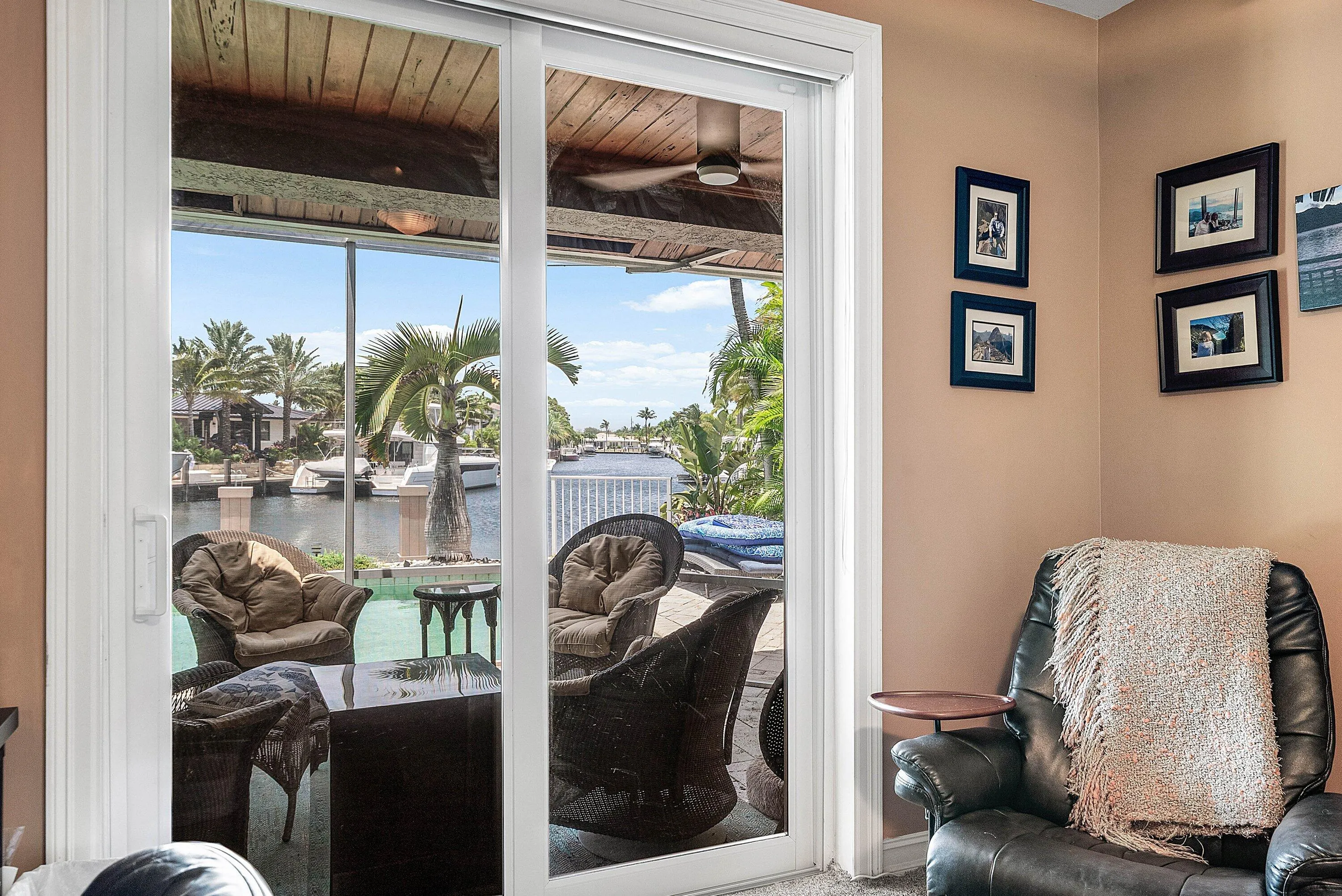 Sliding glass doors opening to an outdoor patio with waterfront access