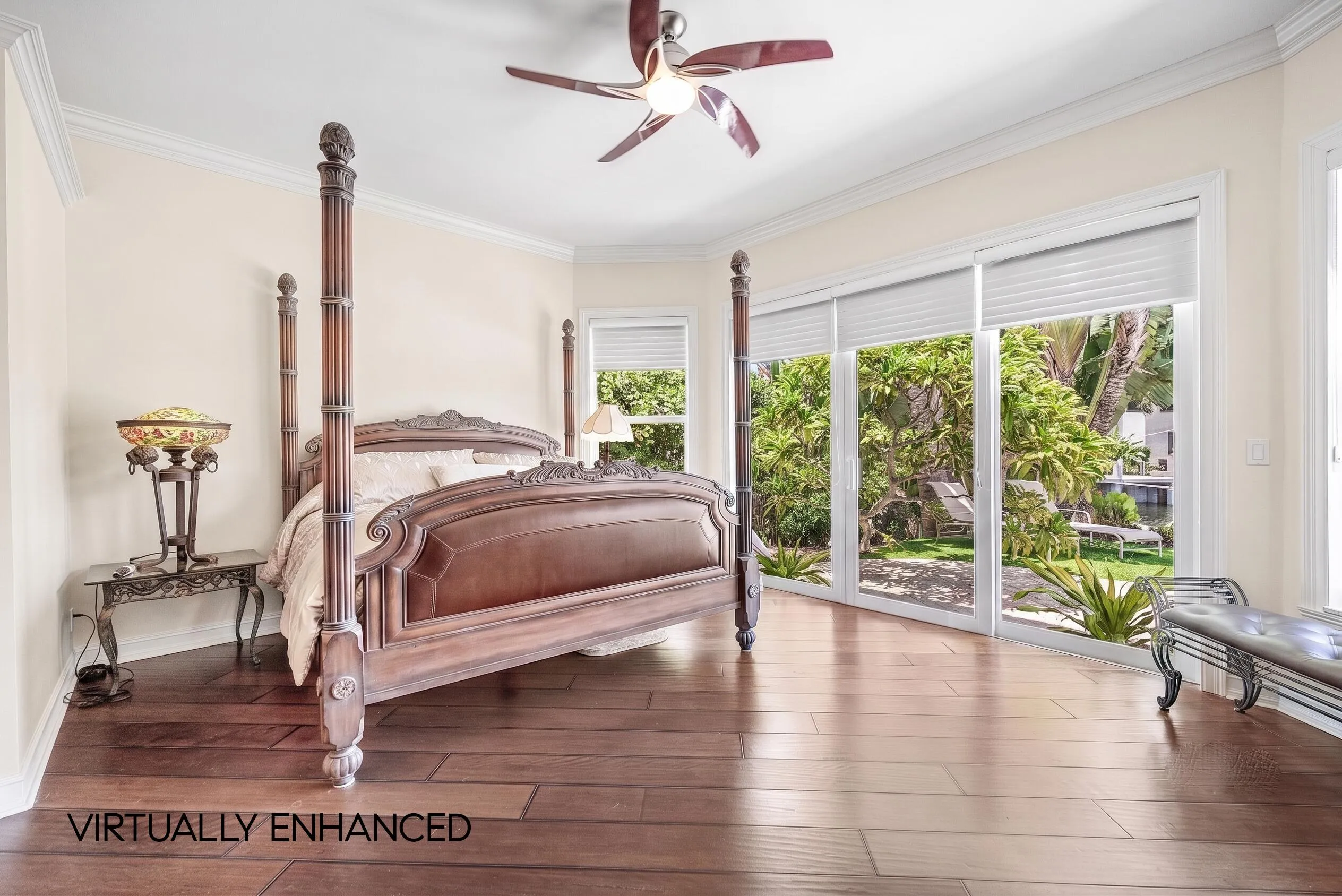 Spacious room featuring wood-finish flooring, light-toned walls, and a ceiling fan