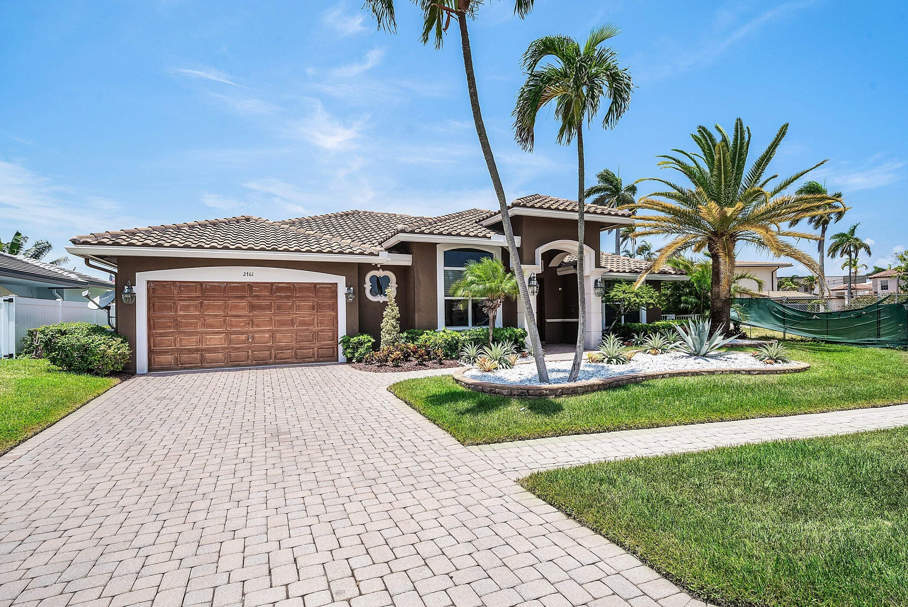 Contemporary stucco exterior with a tiled roof