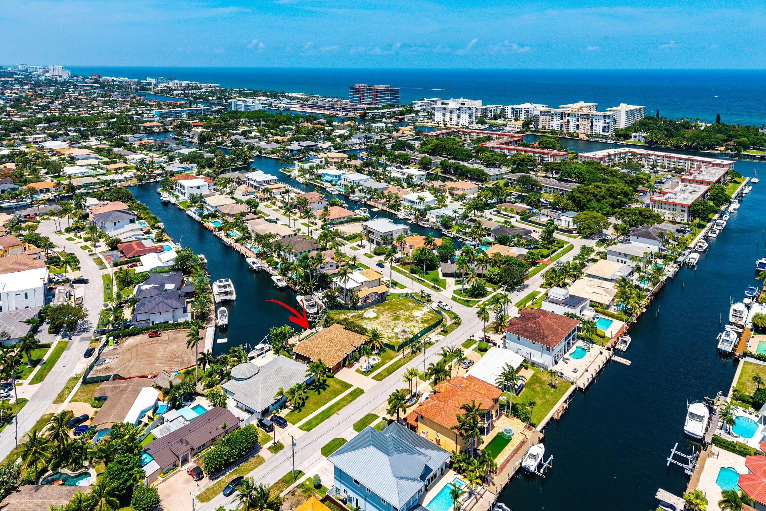 Waterfront property featuring direct canal access, a private dock, mature landscaping, and proximity to coastal waters