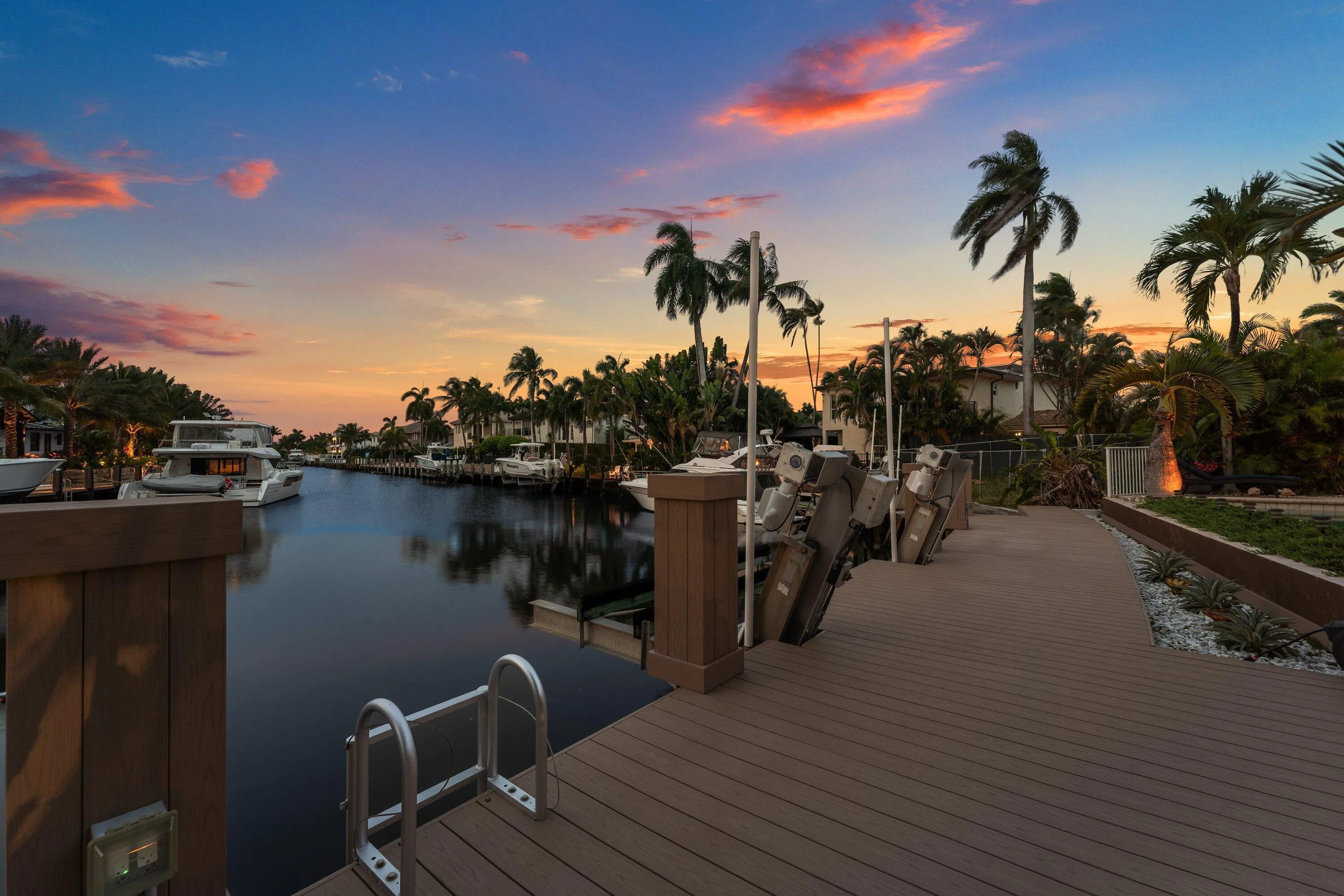 Waterside composite decking featuring multiple boat lifts and direct canal access
