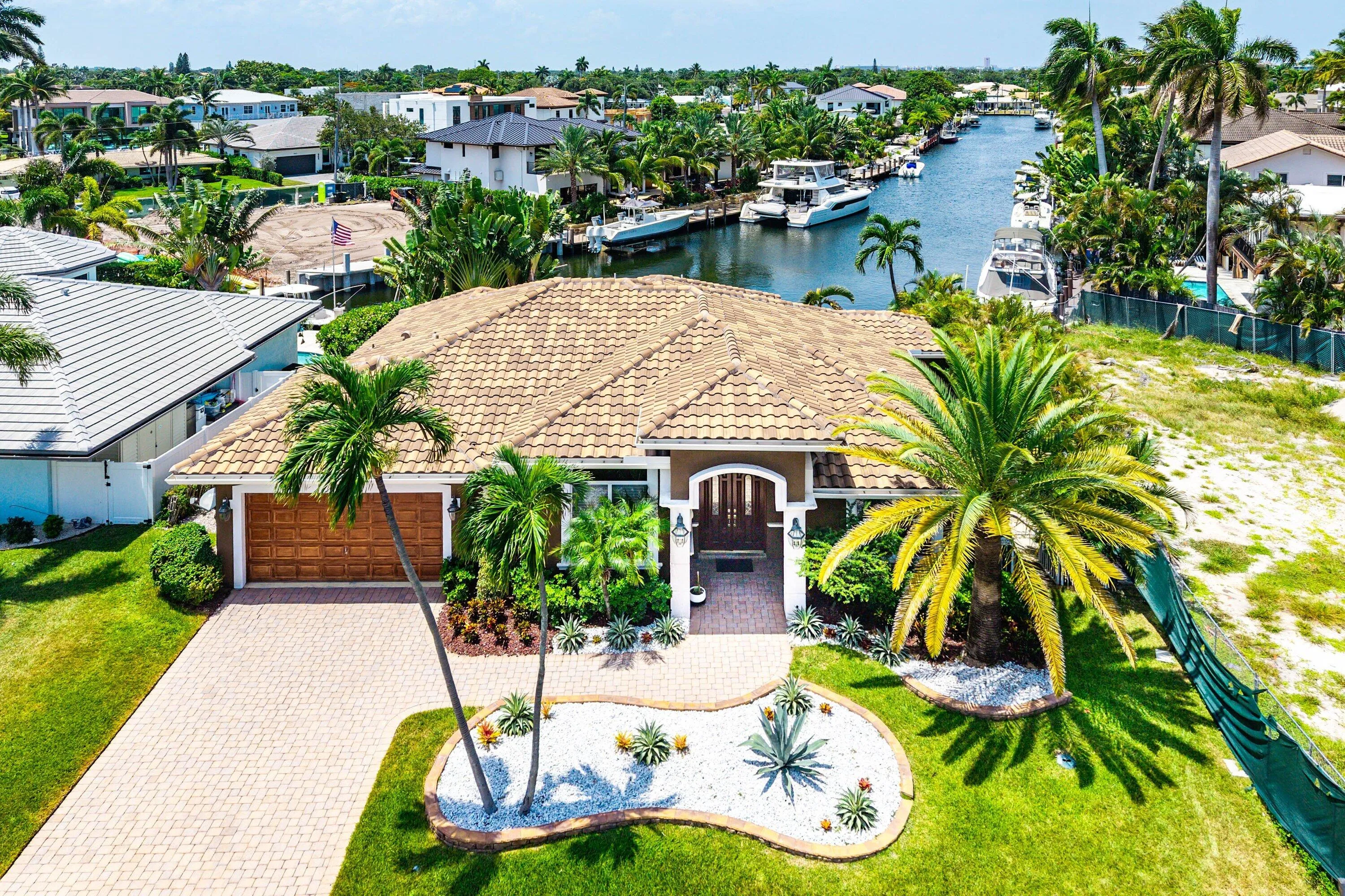 Mediterranean-style residence featuring a tile roof and a paver driveway