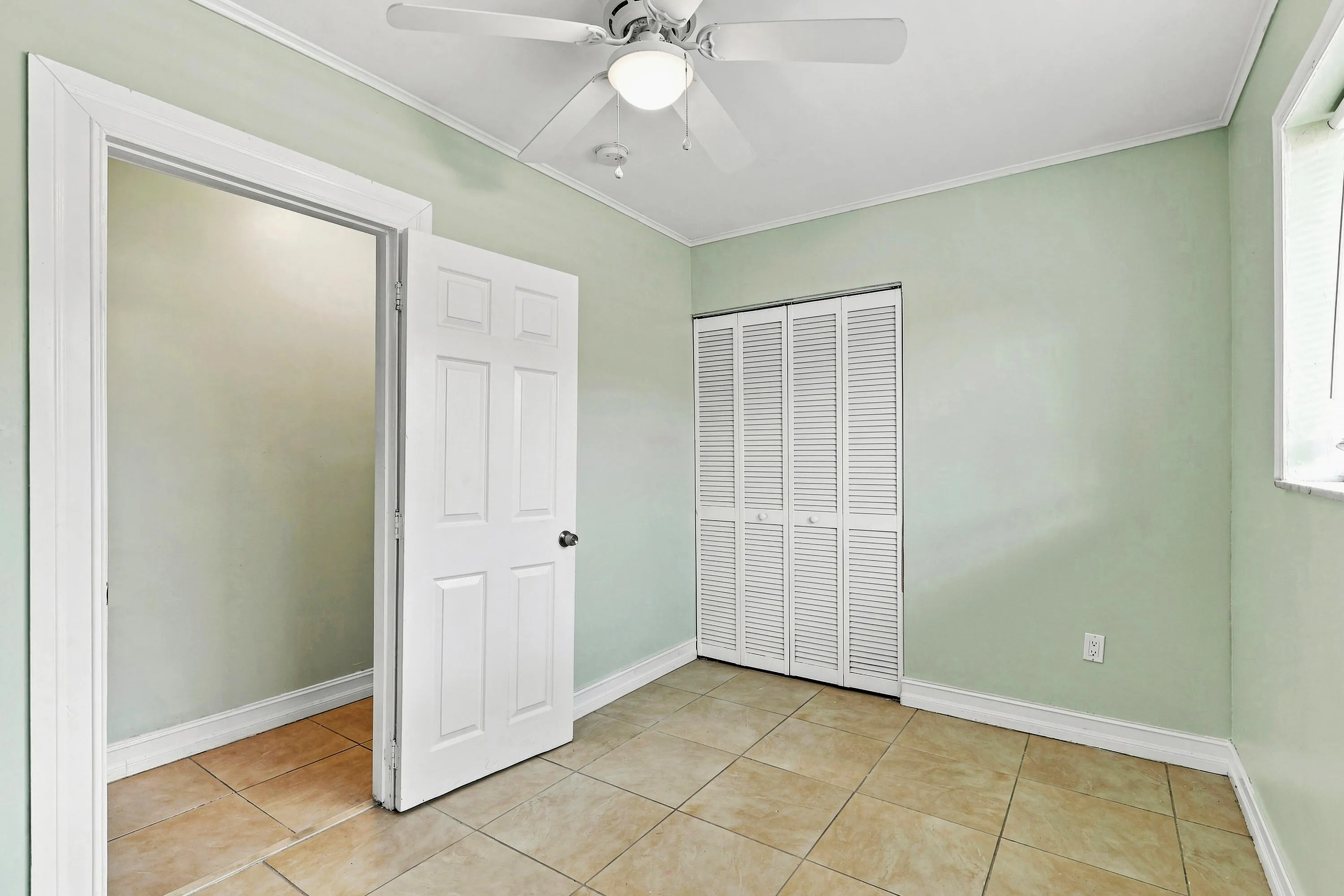Room featuring tile flooring and light green walls