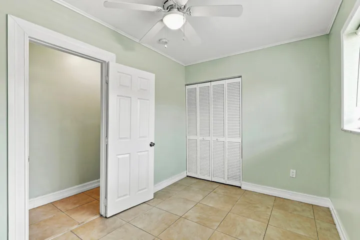 Room featuring tile flooring and light green walls