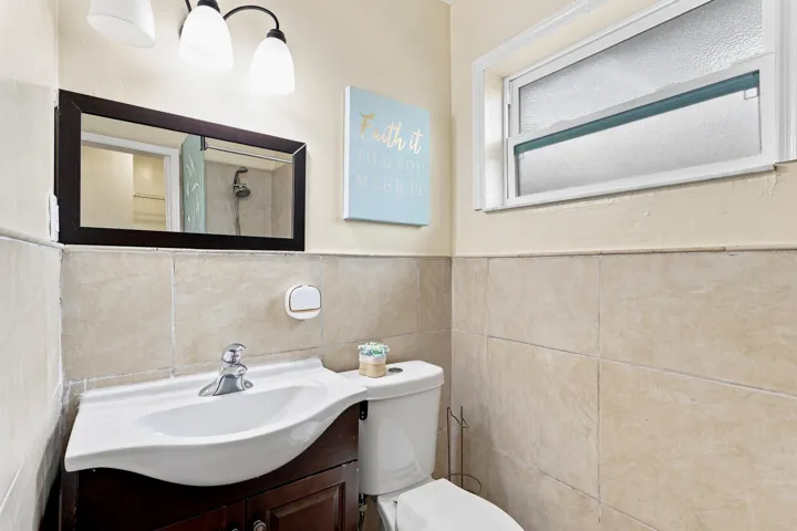 Bathroom vanity with a white ceramic sink and chrome faucet