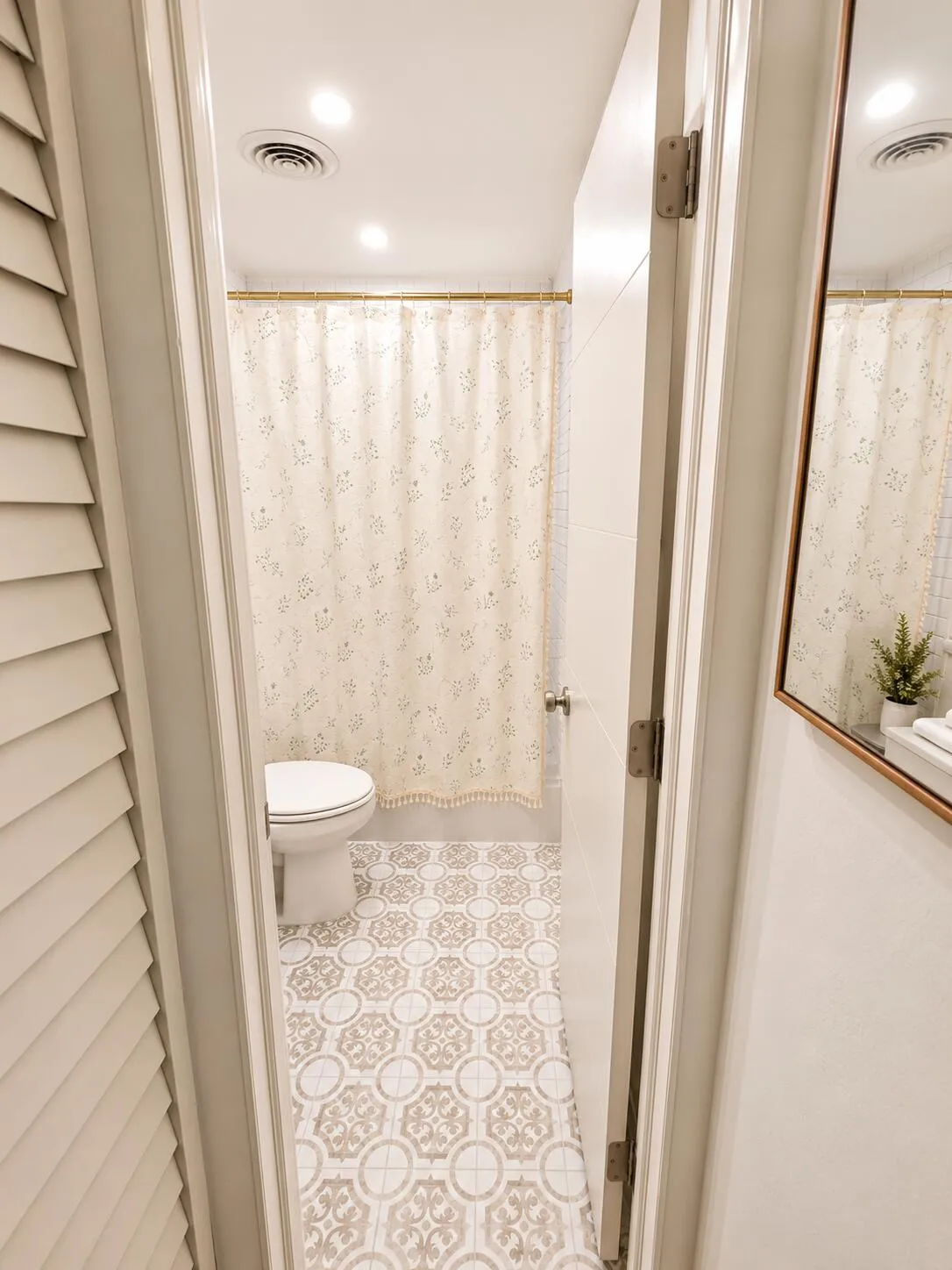 Bathroom featuring patterned floor tiling, a toilet, recessed lighting, and a shower curtain