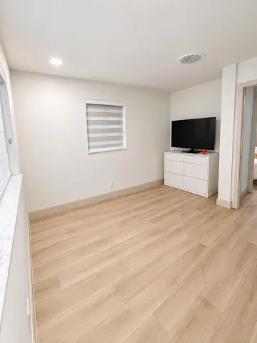 Bright and versatile second bedroom featuring stylish tile flooring, ample natural light, and clean, modern finishes. Perfect for a guest room, nursery, or dedicated home office.