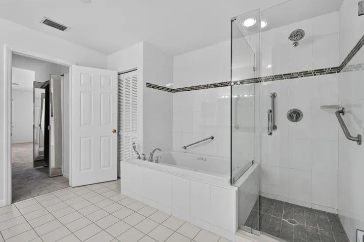 Master Bath frameless shower and Jacuzzi tub.