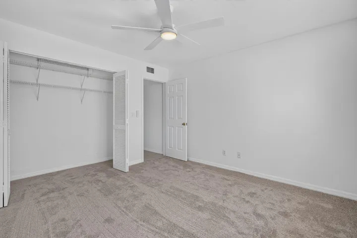 Bedroom 2 with new carpet, paint and fan.