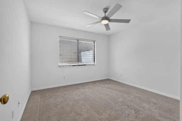 Bedroom 2 with new carpet, paint and fan.