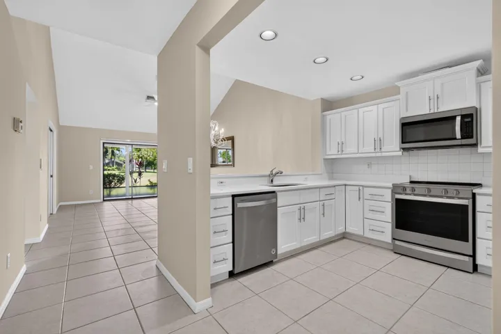Kitchen open to the great room with a view of the colf course.