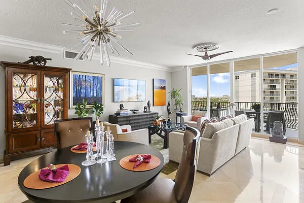 Living/Dining RM w/ designer light fixtures & marble floor through-out home