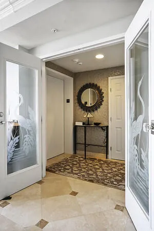 Private foyer entry w/ French doors to main living area