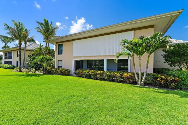 Well-kept grounds and mature palms throughout the community