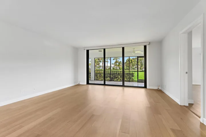 Wide great room with sliders framing the fairway