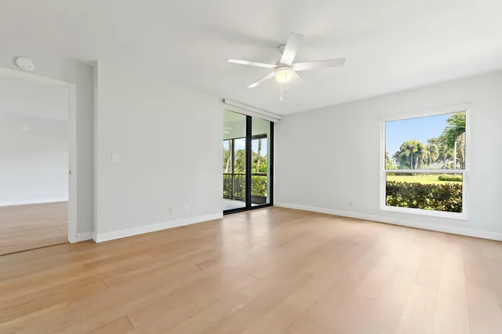 Light-filled room with sliders to the screened patio and fairway views