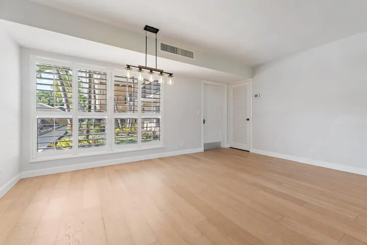 Open dining space with a modern light fixture and plenty of natural light